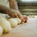 a person kneading dough on top of a counter